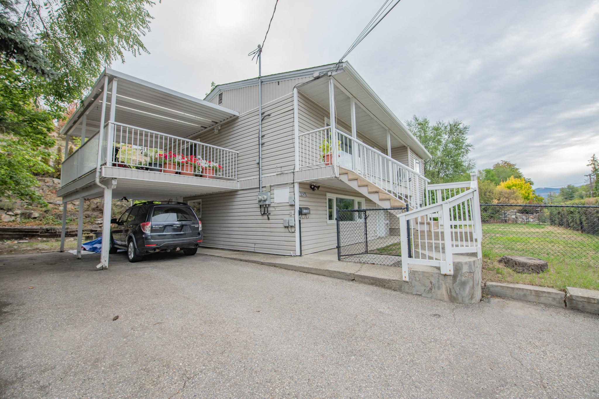 12005 Kalamalka Road exterior with covered deck, parking and fenced yard